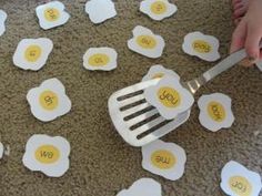 someone is holding a fork over some eggs with words on them that spell out the word we love you