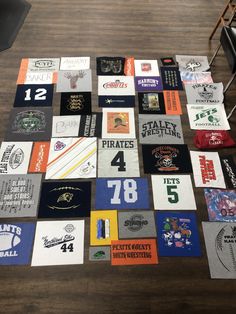 many different t - shirts are laid out on the floor