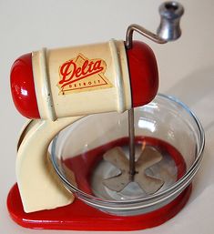 a red and white blender sitting on top of a counter