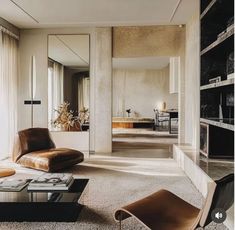 a living room filled with furniture and a large mirror