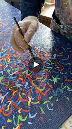 a person is painting letters on a table