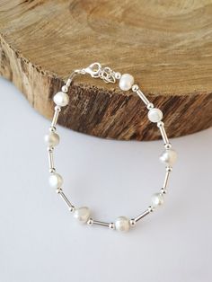 Simple white freshwater pearl bracelet made with silver spacer beads. Adjustable size, will fit most sizes. Nickel free and hypoallergenic. Silver plated. Adjustable Sterling Silver Pearl Charm Bracelet, Adjustable Sterling Silver Beaded Bracelets With Pearl Charm, Adjustable Silver Pearl Bracelet For Everyday, Silver Pearl Beaded Bracelets Minimalist Style, Adjustable White Pearl Sterling Silver Bracelet, Minimalist Silver Beaded Bracelet With Pearl Charm, Minimalist Silver Beaded Bracelets With Pearl Charm, Minimalist Silver Pearl Beaded Bracelets, Adjustable Minimalist Sterling Silver Bracelet