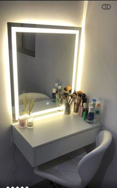 a white desk with a lighted mirror on it