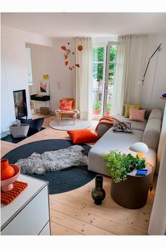 a living room filled with furniture and a fire place in the middle of it's center