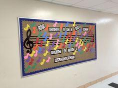 a bulletin board with musical notes on it in an office building hallway or school room