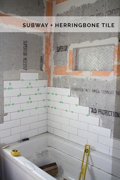 a bath tub sitting inside of a bathroom next to a wall with construction tape on it