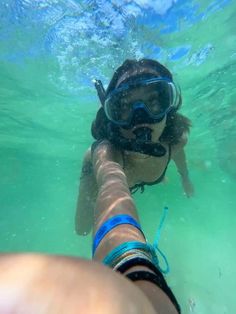 a person swimming in the water with goggles on