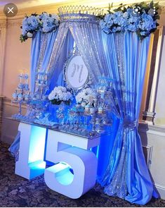 the table is set up with blue and white flowers, candles, and desserts