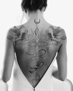 the back of a woman's body with tattoos on it