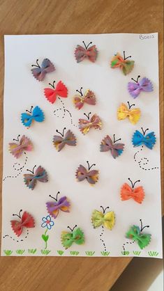 paper butterflies are arranged on a sheet of paper