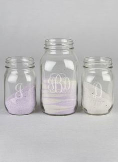 three glass jars with different colored sand in them and the words mr and mrs written on each jar