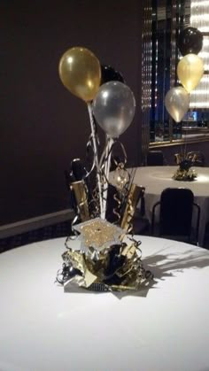 a white table topped with balloons and confetti