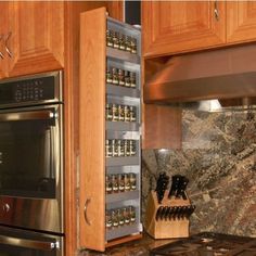 a kitchen with an oven, stove and spice rack on the counter top in front of it