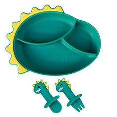 two green dinosaur shaped plates and spoons sitting next to each other on a white background