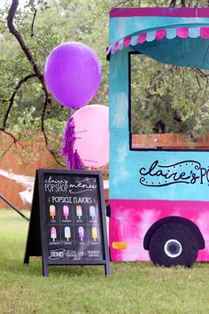 the ice cream truck is decorated with balloons and streamers for an outdoor birthday party