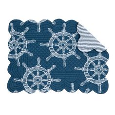 a blue rug with white ships wheels on it