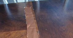 a piece of brown paper sitting on top of a wooden floor