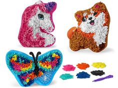 three different types of toys including a butterfly, dog and cat made out of yarn