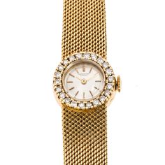 This elegant ladies' watch is ideal for a special night out or simply as a collectable piece. It is an 18K yellow gold International Watch Co. Swiss-made timepiece, with a round shaped champagne coloured dial, yellow stick hour markers and hands, and finished with an 18K gold tapered mesh bracelet with fold-over clasp. Adding to the elegant timepiece are 22 diamonds totaling 0.55 carats (clarity: VS - SI; colour: I-J) that surround the bezel. Measures approximately 6.5" in length. Gram weight: 3 Anniversary Yellow Gold Diamond Watch With Round Dial, Yellow Gold Diamond Watch With Round Dial For Anniversary, Classic Yellow Gold Diamond Watch For Evening, Formal Yellow Gold Diamond Watch With Round Dial, Formal Yellow Gold Diamond Watch, Evening Watches With Jubilee Bracelet And Round Dial, Yellow Gold Watch With Round Dial For Evening, Formal Yellow Gold Round Watch, Evening Round Watch With Jubilee Bracelet