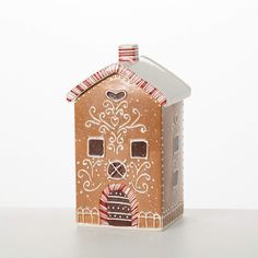 a gingerbread house is decorated with red, white and blue decorations