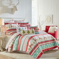 a bed covered in christmas themed comforters and pillows