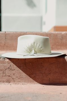 Details The McVie Hat by Wyeth is a fun, unique hat that will quickly become your newest go-to! This Australian cashmere wool hat features a wide brim, a genuine leather tie band, hand-stitched sun embroidery detailing and a Selenite crystal! Rancher style Wide brim All accessories are final sale. Contents 100% Cashmere wool Genuine leather band Care Spot clean using a damp cloth and mild soap. Air dry in a space out of direct sunlight. Rancher Hat Outfits, Bohemian Hat, Casual Wedding Outfit, Sun Embroidery, Bohemian Hats, Custom Cowboy Hats, Hat Aesthetic, Rancher Hat, Embroidery Detailing