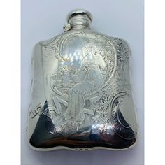 a silver flask with an image of a woman on the front and back side