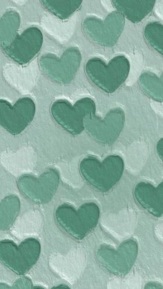 many green hearts are arranged in the shape of heart shapes on a light blue background