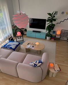 a living room filled with furniture and a flat screen tv mounted to the side of a wall