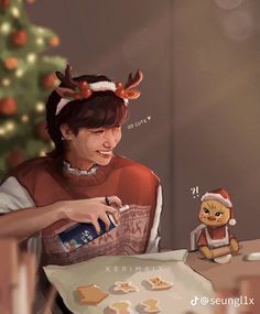 a woman sitting at a table in front of a christmas tree with cookies on it