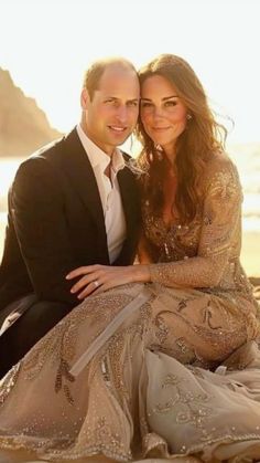 prince william and kate are posing for a photo on the beach in their wedding dress