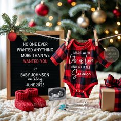 a baby's first christmas outfit and other items on a blanket next to a christmas tree