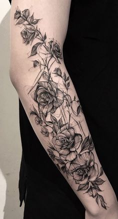 a woman's arm with flowers and leaves on the left side of her body