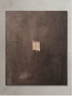 an abstract painting with brown and white paint on the wall, in front of a gray background