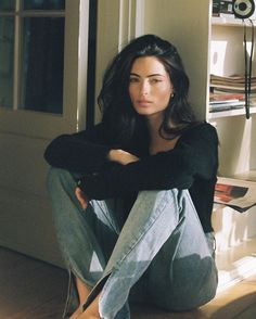 a woman sitting on the floor with her legs crossed