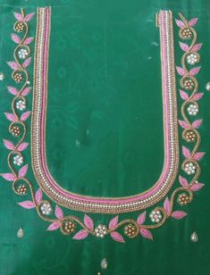 a green cloth with pink and white beads on it