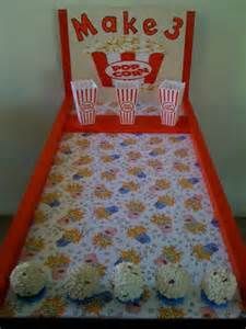 a bed made to look like a movie theater with cupcakes on the bottom