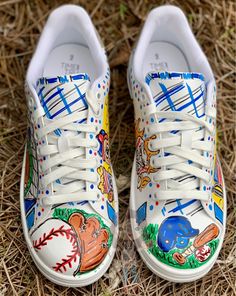 a pair of shoes painted with baseball images