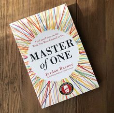 the book master of one by jordan rayner on a wooden table with a pen in it