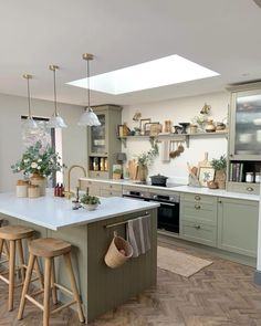 a large kitchen with an island in the middle and lots of counter space on one side