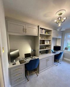 a home office with built in desk and shelves