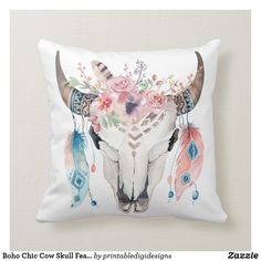 a pillow with a cow skull and flowers on it