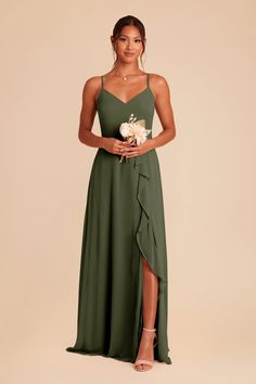 a woman wearing a green bridesmaid dress with an asymmetrical skirt