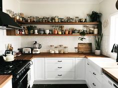 a kitchen filled with lots of open shelves