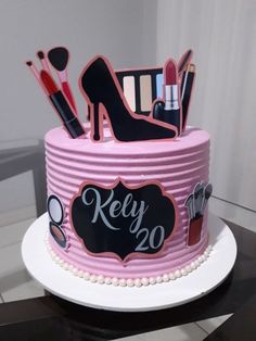 a pink cake with black and white designs on it's side that says kelly 20