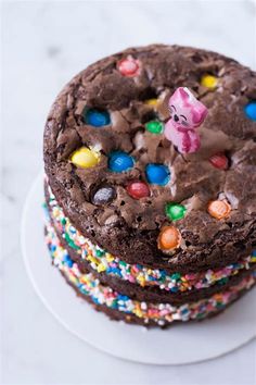 two chocolate cookies stacked on top of each other with m & m candies around them