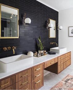 the bathroom is decorated in black and white with gold accents, including two double sinks