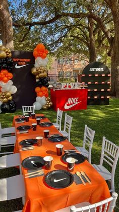 an orange and white table set up with black plates