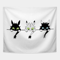 three black cats with green eyes are hanging on a white wall and one is holding the string