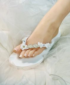 Wedding Lt Ivory Shoes,Bridal Flip Flops,Beach Wedding Shoes,Bridesmaid Slippers ,Floral Wedding Sandals, Rhinestone Flip Flops -SD047 We made with white flat flip flop decorated with Off white Flower .It is shining with a clear crystal on the lace. These flip flops are designed for brides and bridesmaids looking for style. Model shoe size US 8. Quantity:one order is 1 pair (2 pcs). Pearl White Summer Wedding Shoes, Summer Bridal Accessories For Bridal Shower, Summer White Bridal Accessories For Bridal Shower, White Summer Bridal Accessories For Bridal Shower, White Bridal Accessories For Summer Bridal Shower, Elegant White Wedding Shoes For Beach Wedding, Elegant White Wedding Shoes For Beach, Elegant White Beach Wedding Shoes, White Round Toe Beach Wedding Shoes